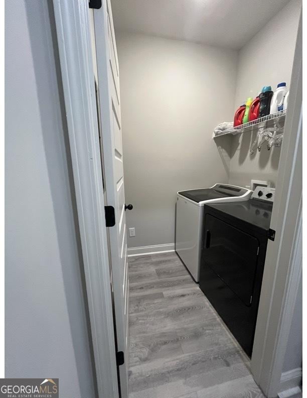 4529 Jersey Covington Rd, Covington, GA 30014 - laundry area with washing machine and dryer and wood finished floors