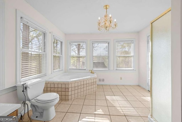 full bathroom featuring a bath, visible vents, toilet, tile patterned floors, and a notable chandelier