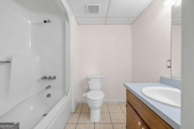 full bathroom featuring visible vents, toilet, tile patterned floors, vanity, and a drop ceiling