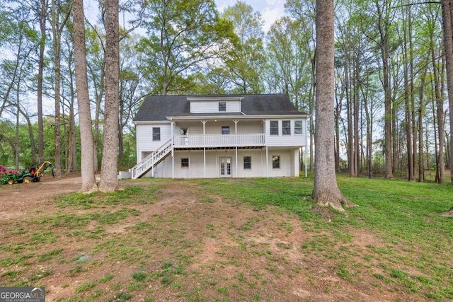 back of house featuring a wooden deck, stairway, and a lawn