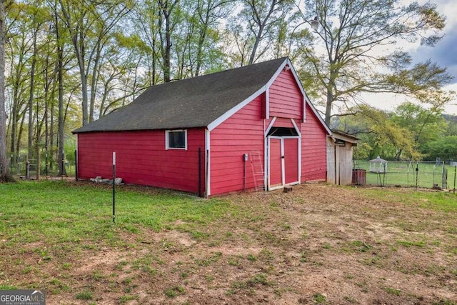 view of outbuilding featuring an outbuilding and fence
