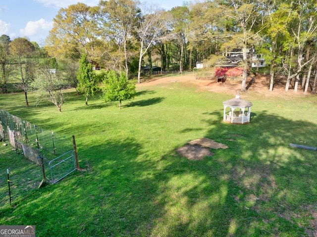view of yard with fence and a gazebo