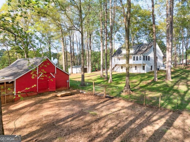 view of yard featuring stairs and an outbuilding