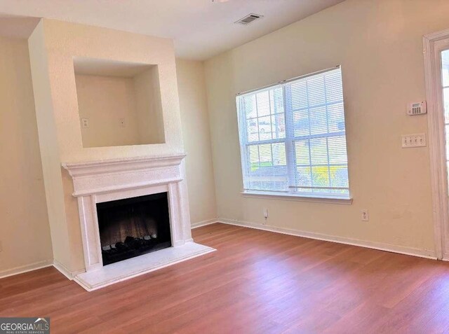 290 Brookview Dr, Riverdale, GA 30274 - unfurnished living room with a fireplace, visible vents, baseboards, and wood finished floors