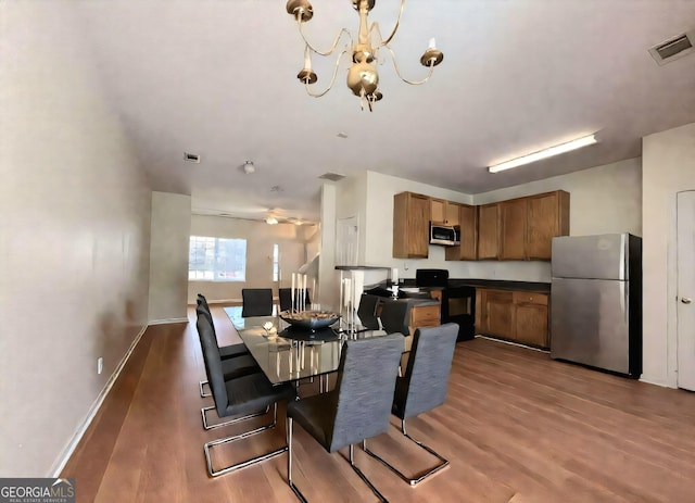 290 Brookview Dr, Riverdale, GA 30274 - dining room with visible vents, baseboards, an inviting chandelier, and dark wood-style floors
