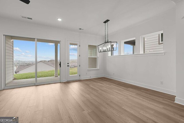 unfurnished dining area with recessed lighting, baseboards, a chandelier, visible vents, and wood finished floors