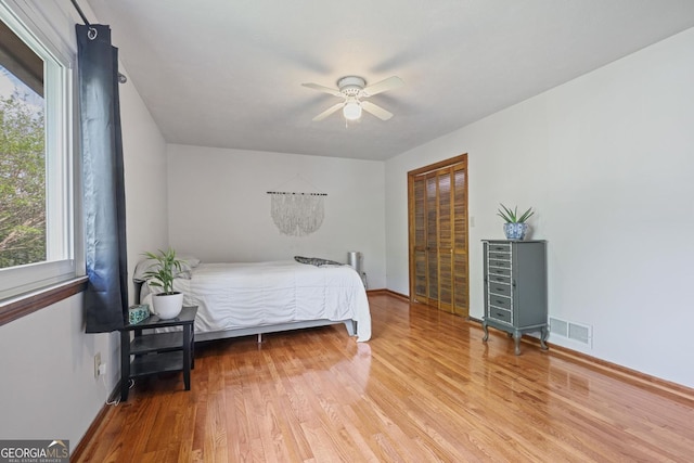 3916 S Martin Way, Lithia Springs, GA 30122 - bedroom with baseboards, visible vents, multiple windows, and wood finished floors