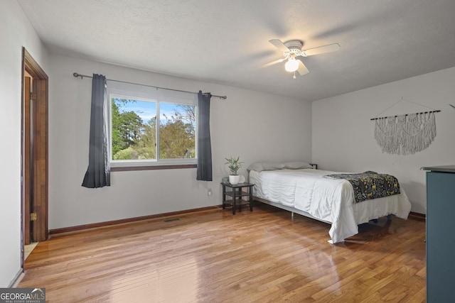3916 S Martin Way, Lithia Springs, GA 30122 - bedroom with baseboards, ceiling fan, light wood-type flooring, and visible vents