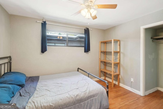 bedroom featuring baseboards, ceiling fan, and wood finished floors