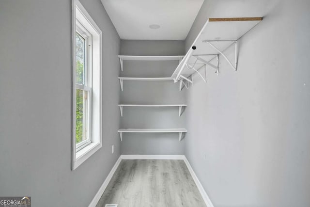 spacious closet with wood finished floors
