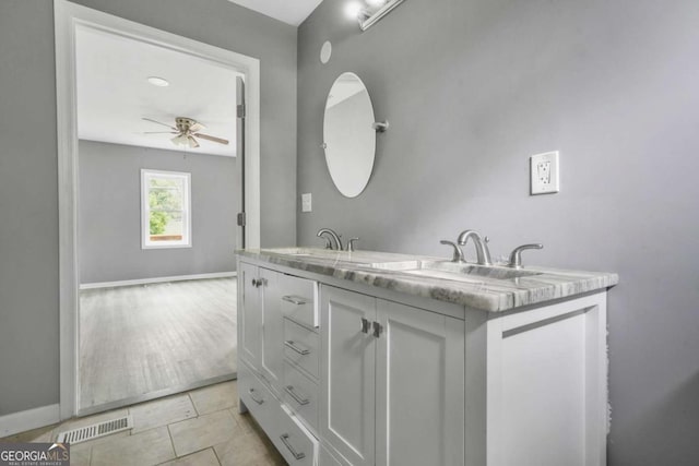 bathroom featuring tile patterned floors, a sink, visible vents, a ceiling fan, and double vanity