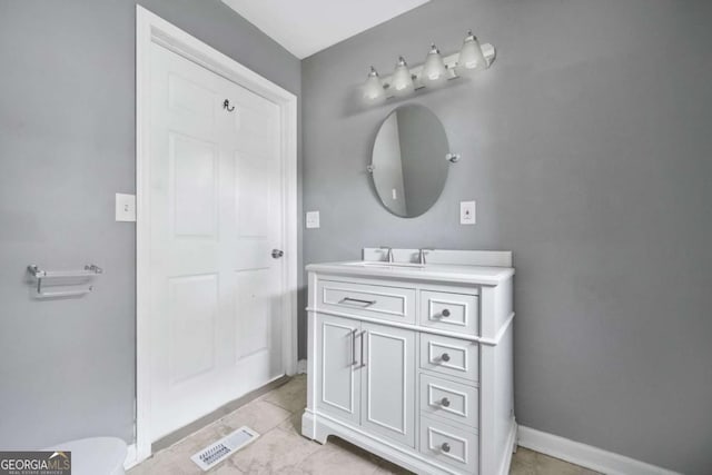 bathroom with baseboards, visible vents, and vanity