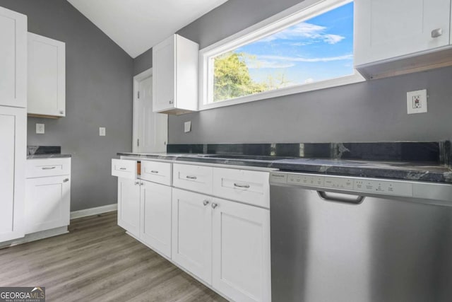 kitchen with white cabinetry, vaulted ceiling, baseboards, dishwasher, and light wood-style flooring