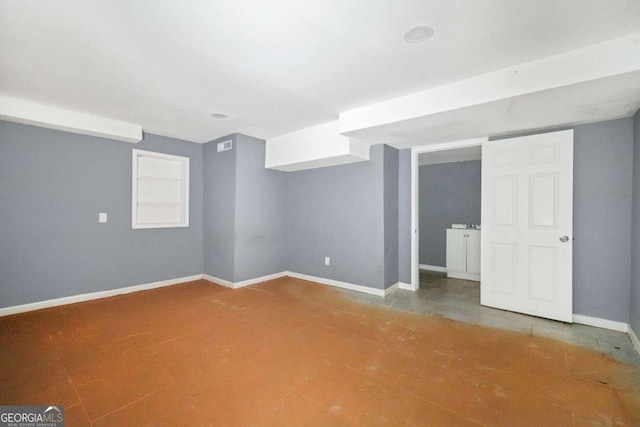 finished below grade area featuring baseboards and visible vents