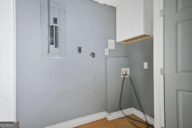 washroom featuring hookup for a washing machine, baseboards, cabinet space, electric dryer hookup, and electric panel