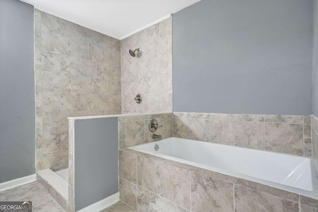 bathroom featuring a tile shower and a garden tub