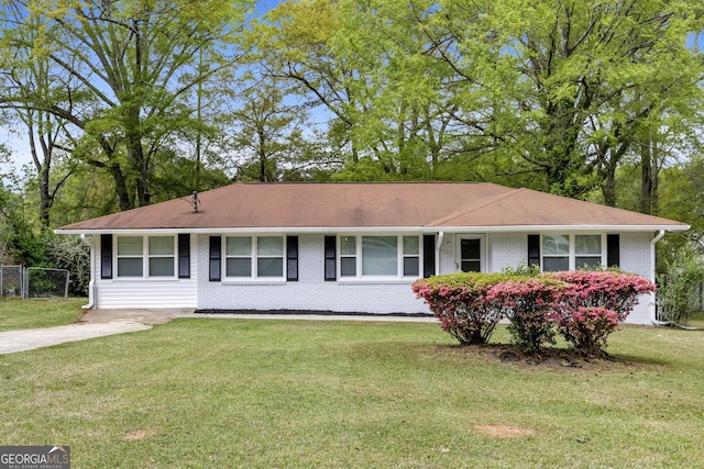 ranch-style home featuring brick siding and a front yard