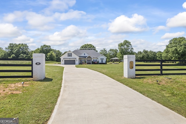 209 Unawatti Rd, Canon, GA 30520 - view of front facade featuring a front yard, driveway, fence, and an attached garage