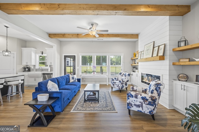 209 Unawatti Rd, Canon, GA 30520 - living area featuring a ceiling fan, beamed ceiling, a fireplace, and wood finished floors
