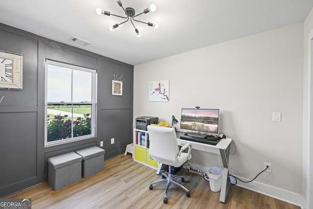 209 Unawatti Rd, Canon, GA 30520 - home office featuring baseboards, visible vents, wood finished floors, and a decorative wall