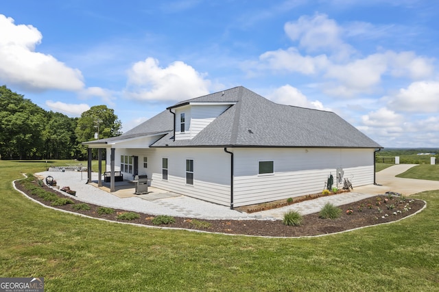 209 Unawatti Rd, Canon, GA 30520 - view of home's exterior featuring a lawn, a shingled roof, and a patio area