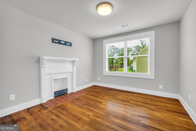 68 Hayes St, Toccoa, GA 30577 - unfurnished living room featuring wood finished floors, baseboards, and a fireplace
