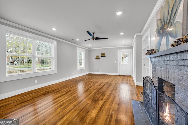 68 Hayes St, Toccoa, GA 30577 - unfurnished living room with crown molding, a ceiling fan, a brick fireplace, baseboards, and wood finished floors