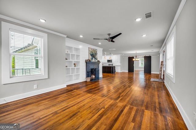 68 Hayes St, Toccoa, GA 30577 - unfurnished living room featuring a ceiling fan, baseboards, a fireplace, ornamental molding, and dark wood-style floors