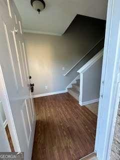 interior space with baseboards, stairs, and wood finished floors