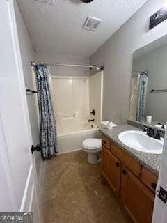 bathroom featuring toilet, vanity, and shower / bath combo with shower curtain