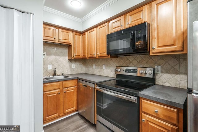 771 Jordan Ln Unit K, Decatur, GA 30033 - kitchen with appliances with stainless steel finishes, dark countertops, crown molding, light wood-type flooring, and backsplash