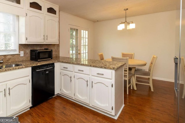 kitchen with white cabinetry, black appliances, a chandelier, and a peninsula
