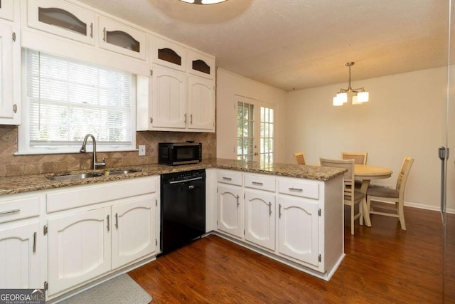 kitchen featuring dark wood-type flooring, a sink, white cabinets, a peninsula, and black appliances