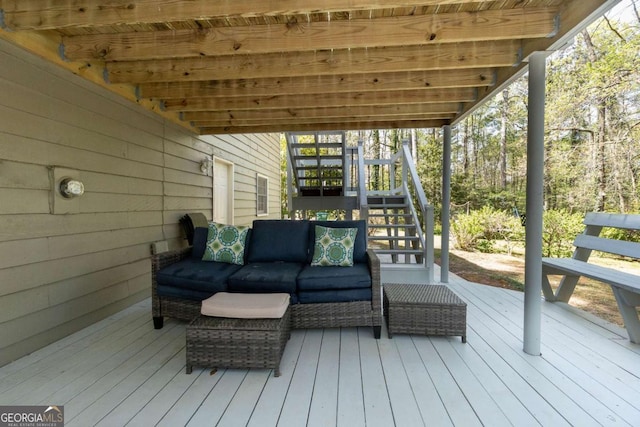 wooden deck with an outdoor living space and stairway