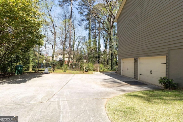 view of side of home featuring driveway and a garage