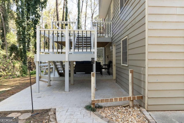 view of patio with a wooden deck and stairway