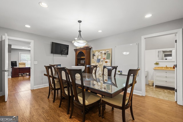 dining space with recessed lighting, baseboards, and wood finished floors