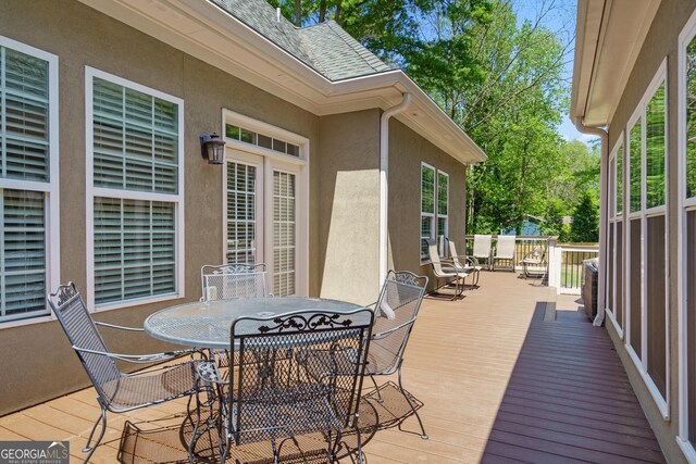 wooden terrace featuring outdoor dining space