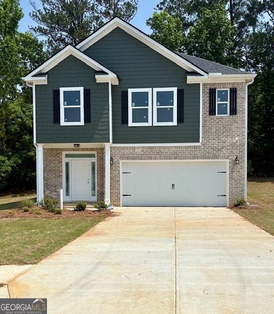 105 Hunts Mill Cir, Griffin, GA 30224 - view of front of home featuring an attached garage, brick siding, and concrete driveway