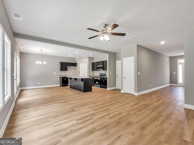 105 Hunts Mill Cir, Griffin, GA 30224 - unfurnished living room featuring a ceiling fan, a chandelier, light wood-style flooring, and recessed lighting