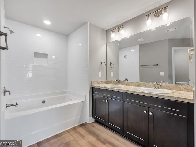 105 Hunts Mill Cir, Griffin, GA 30224 - bathroom featuring wood finished floors, double vanity, and  shower combination