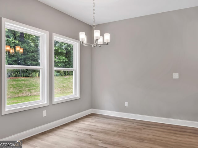 105 Hunts Mill Cir, Griffin, GA 30224 - unfurnished room with a chandelier, plenty of natural light, and light wood-style flooring