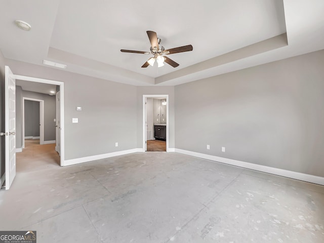105 Hunts Mill Cir, Griffin, GA 30224 - unfurnished bedroom with a tray ceiling, a ceiling fan, and ensuite bath