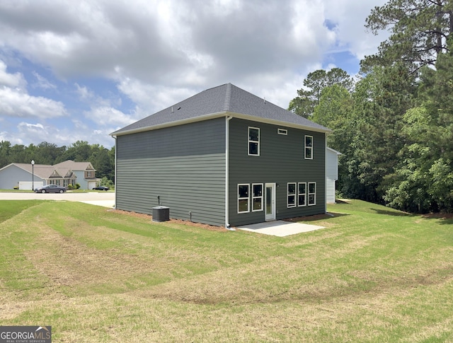 105 Hunts Mill Cir, Griffin, GA 30224 - view of side of home featuring a yard, a patio area, and view of wooded area