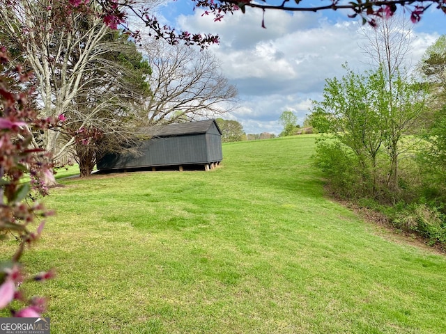 2210 Holly Springs Rd, Rockmart, GA 30153 - view of grassy yard with a storage shed