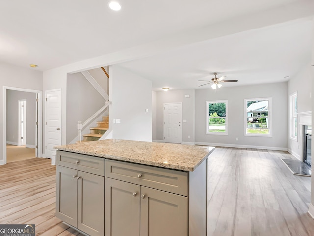 131 Hunts Mill Cir, Griffin, GA 30224 - kitchen with light wood-style flooring, ceiling fan, gray cabinetry, open floor plan, and recessed lighting
