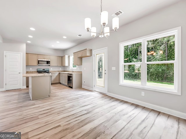 131 Hunts Mill Cir, Griffin, GA 30224 - kitchen featuring appliances with stainless steel finishes, a chandelier, light countertops, light wood-type flooring, and a kitchen island