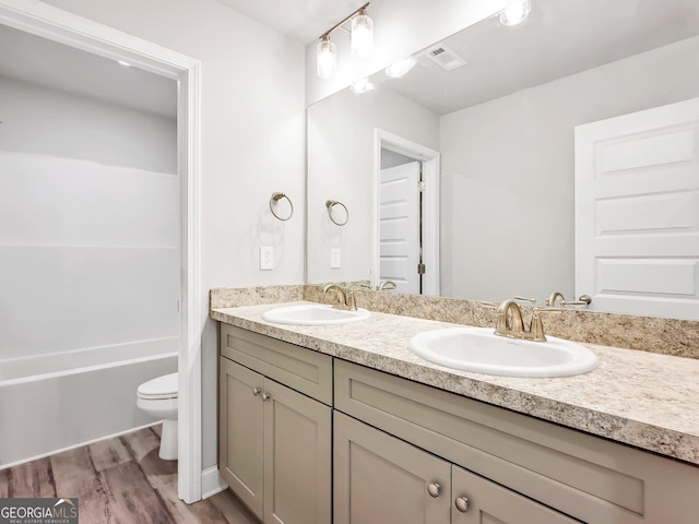 131 Hunts Mill Cir, Griffin, GA 30224 - bathroom featuring double vanity, wood finished floors, and shower / bathtub combination