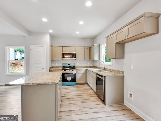 131 Hunts Mill Cir, Griffin, GA 30224 - kitchen with stainless steel appliances, recessed lighting, light stone counters, light wood-style flooring, and a kitchen island