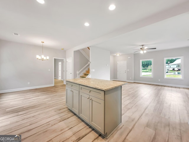 131 Hunts Mill Cir, Griffin, GA 30224 - kitchen with gray cabinets, open floor plan, a kitchen island, light wood-style floors, and ceiling fan